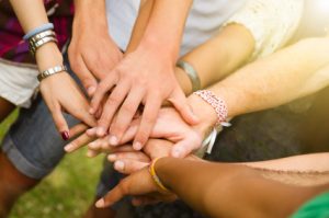 A group of people, hands together
